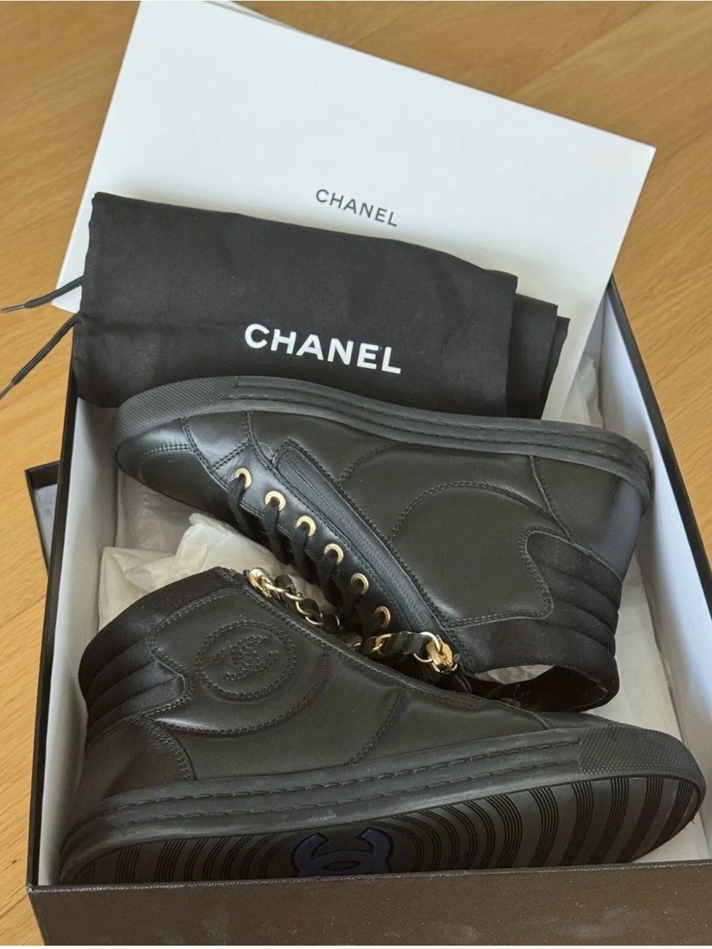 CHANEL Black Quilted High-Top Leather Sneakers with Gold Hardware